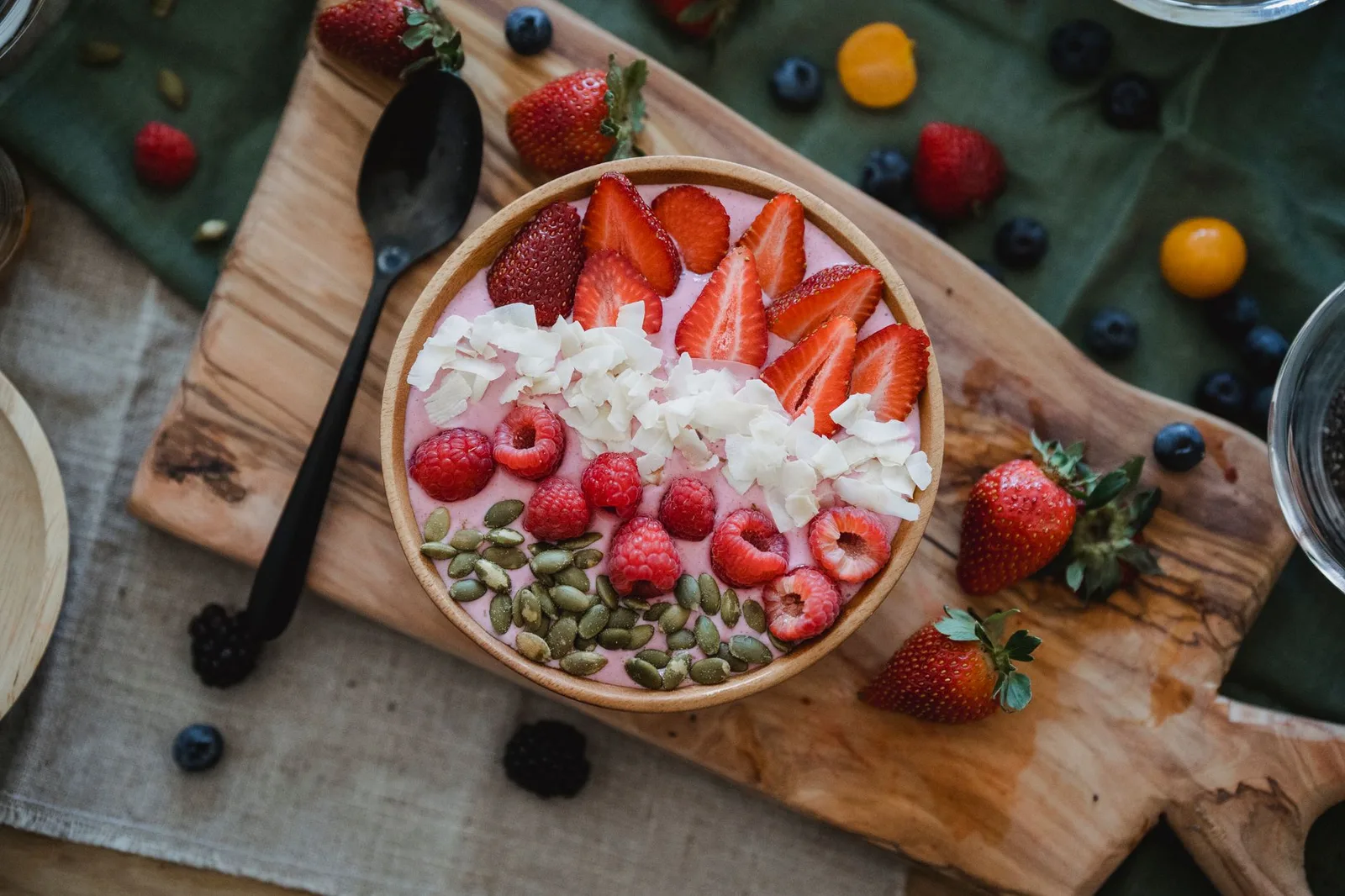 Bright and colorful smoothie bowl topped with fresh berries, seeds, and coconut flakes for a nutritious start.